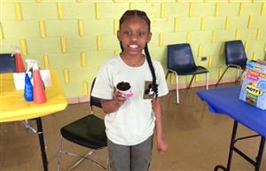 Girl student holding her planting project